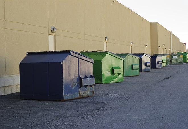 a row of industrial dumpsters at a construction site in Doddridge